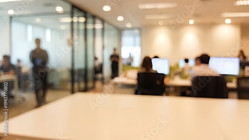 Blurred Office Scene People Working at Desks in Modern Workspace.