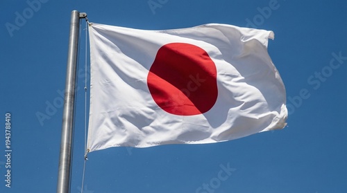 Obraz na plátně National Flag of Japan Waving Against a Clear Blue Sky