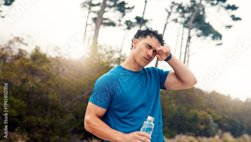 Fotografia Tired, water and fitness with man in nature for workout fatigue, running performance and health