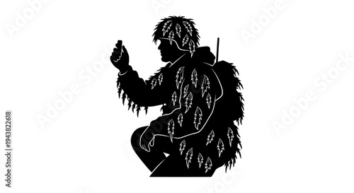 Silhouette of a hunter in camouflage suit with leaves, holding a small object, crouching