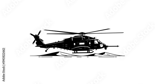 Silhouette of a military helicopter hovering over desert terrain at sunset