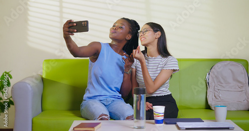 Photography Happy young adult gen z woman sitting on sofa couch use mobile look cam take sel