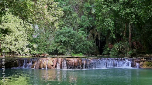 Beautiful Tranquil scenery of water stream flowing through the rocks surrounded by lush foliage trees in rainforest at Than Bok Khorani National Park. Krabi Province. Thailand.