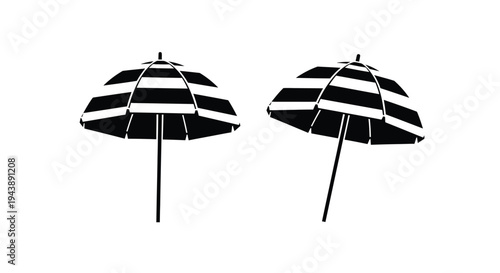 Two black and white striped beach umbrellas on a white background