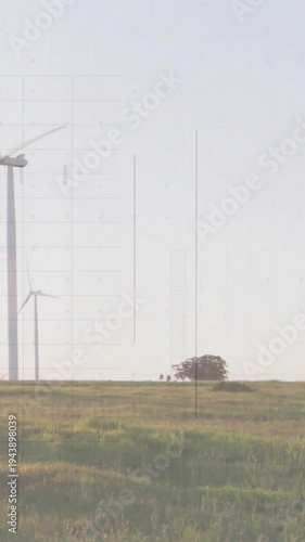Vertical video: Camera panning right, pair near trees, scan lines revealing wind farm over figures