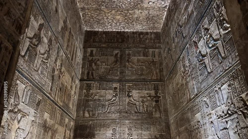 Detailed view of ancient Egyptian wall reliefs and hieroglyphics with remarkably preserved original colors and pigments inside the Temple of Hathor in Dendera