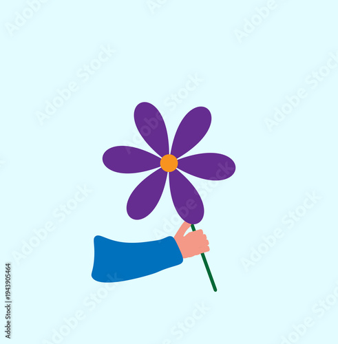 a flower in a person's hand on a light background,