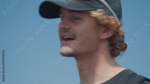 Portrait of the young man talking during outdoor interview
