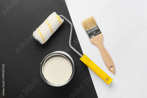 Roller with can of white pa...