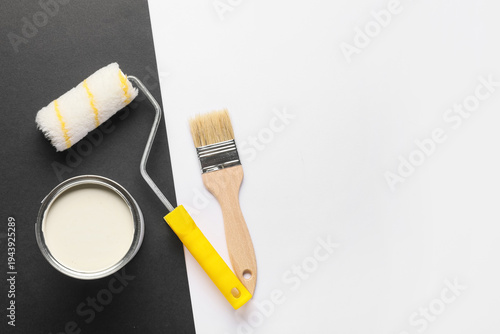 Roller with can of white pa...