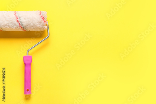 Paint roller on yellow back...