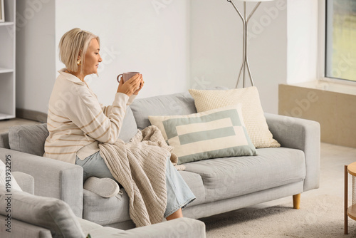 Mature woman with cup of te...