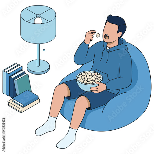 Man sitting on beanbag eating popcorn and reading books next to lamp