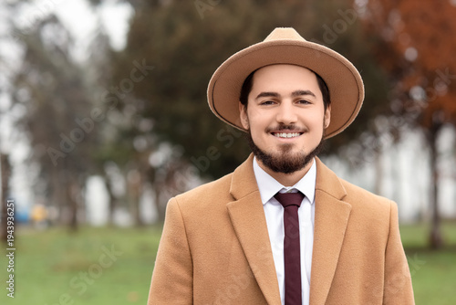Stylish young man in coat w...