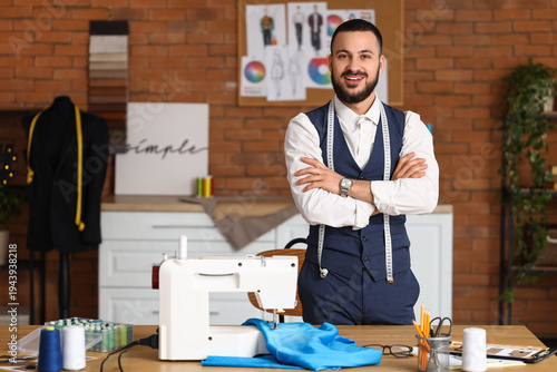 Male tailor with sewing mac...