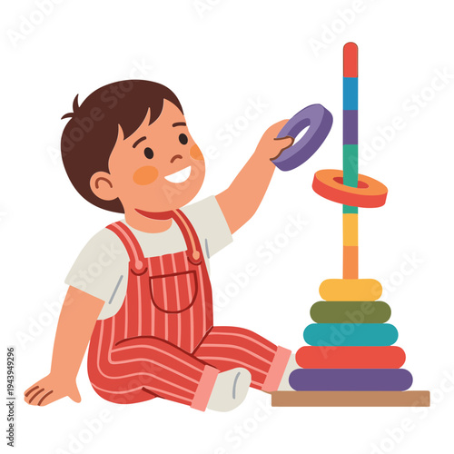 A young boy playing with colorful stacking toy rings on the floor