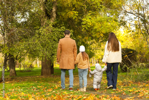 Happy family walking in aut...