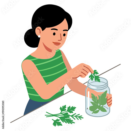 Woman putting leafy greens into a glass jar on a table indoors
