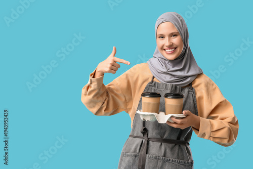 Happy young female barista ...