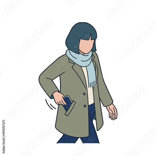 Woman walks while looking down at her phone in a coat and scarf.