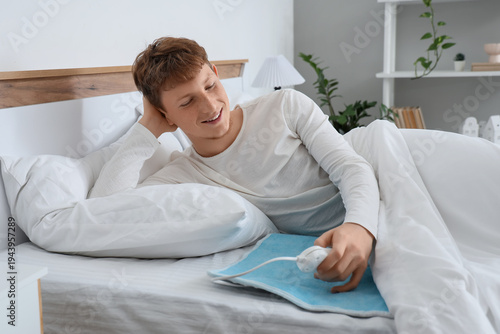 Young man turning on electr...