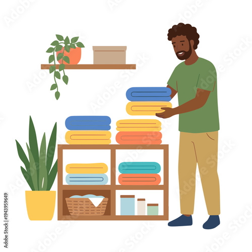 Man stacking colored towels on a shelf with plants
