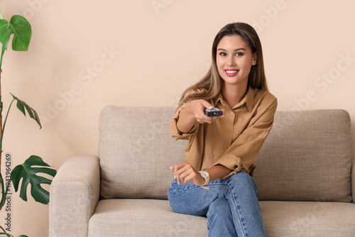 Young woman with remote con...