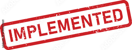 A red textured rubber stamp with the word IMPLEMENTED is shown on a clean white surface