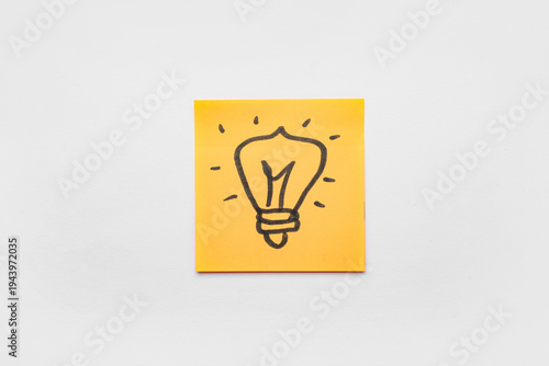 Sticky note with drawn ligh...