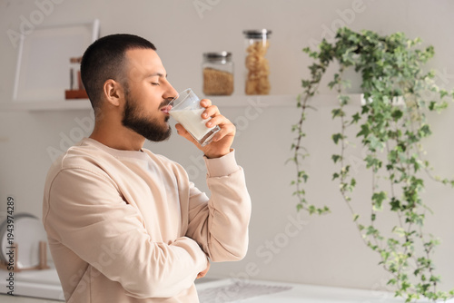 Handsome man drinking milk ...