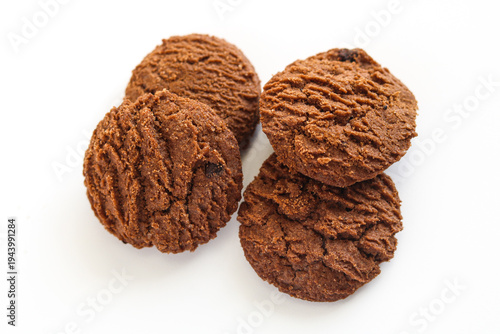 Four chocolate cookies with a unique rippled texture isolated on white.