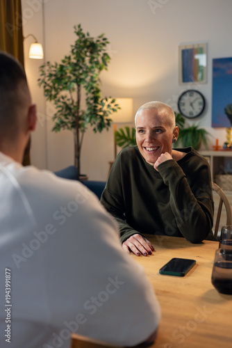 Couple having intimate conversation at home dinner table