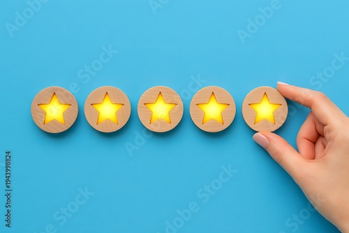 Hand places the final glowing wooden star into a perfect five-star rating lineup on a vibrant blue background, symbolizing top-tier customer satisfaction and premium service quality.