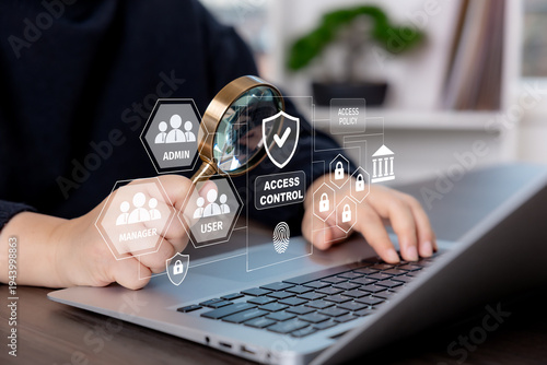 Billede på lærred Businesswoman using laptop with access control interface, user roles, identity management, and security policy icons for secure authentication and permission management