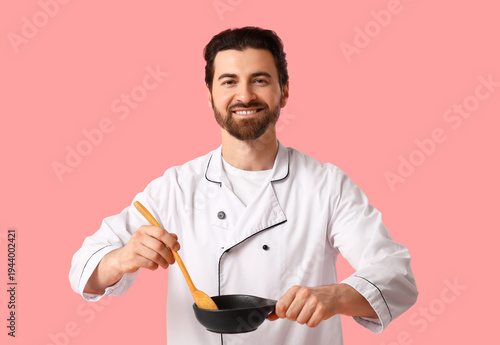 Young happy male chef with ...