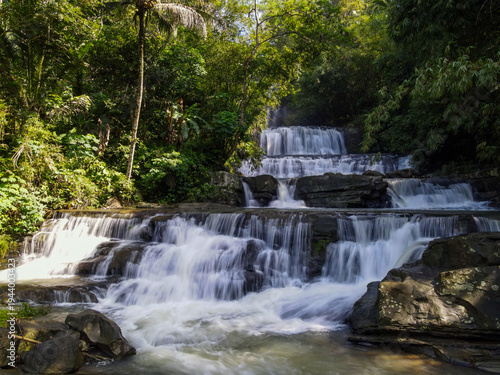 Epic Aerial View of Nangga Tiered Waterfall in Tropical Forest, Central Java Indonesia. Long Exposure Drone Shot 