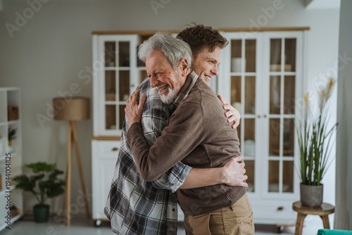 Senior father and adult son embracing with happiness