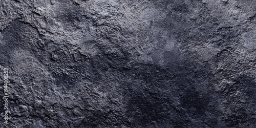 A dark blue and black stone wall features a rough grunge texture with a weathered marble pattern on a grey concrete surface, creating an old granite backdrop for architectural design