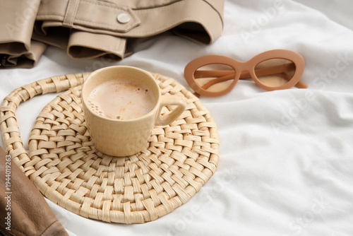 Mat with cup of coffee, sun...
