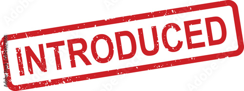 A red rectangular textured rubber stamp displays the word INTRODUCED on a bright white surface