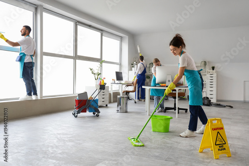 Female Asian janitor moppin...