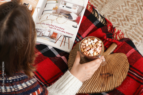 Young woman with cup of hot...