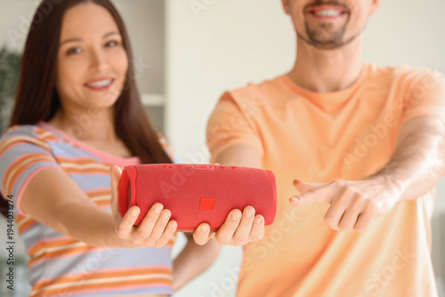 Young couple with portable ...