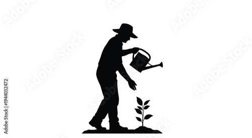 Silhouette of a gardener watering a small growing plant outdoors