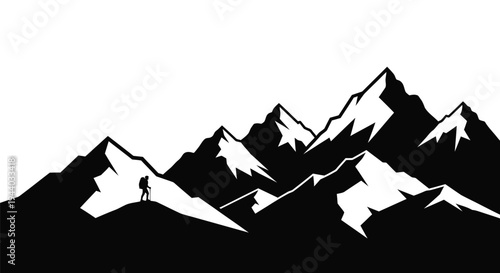 Silhouette of a hiker amidst a striking mountain range landscape