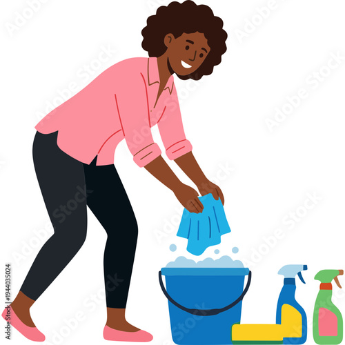 A woman cleans with a rag and bucket of soapy water indoors with supplies.