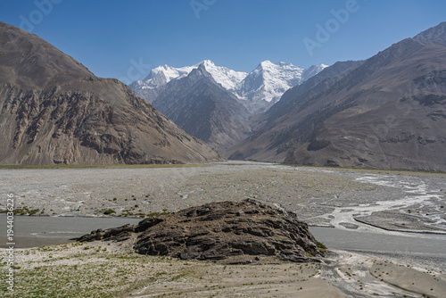 Scenic summer landscape view of Hindu Kush snowcapped peaks and Panj river on Afghanistan side of Wakhan Corridor, Gorno-Badakhshan, Tajikistan Pamir