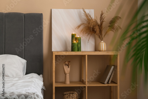 Green burning candles on sh...