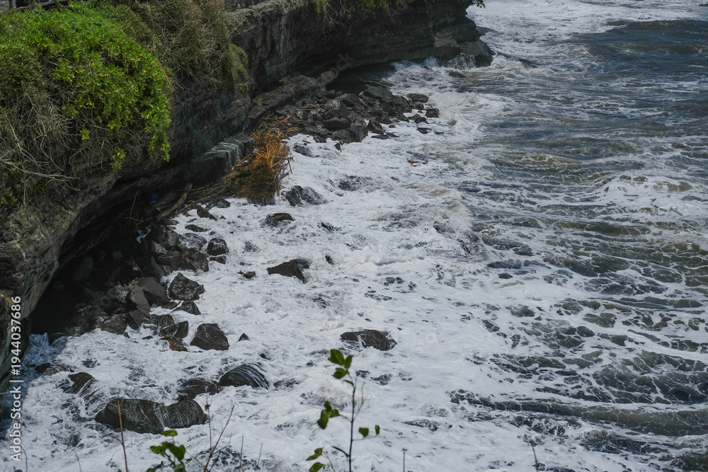 Fototapeta premium Powerful White Ocean Waves Crashing Against Rocky Shore, Dramatic Coastal Seascape