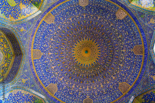 A detailed top-view of a Ornate blue mosaic dome ceiling of the Shah Abbas Mosque in Isfahan, Iran, showcasing intricate Persian tilework, repetitive geometric patterns and rich colors that evoke awe,